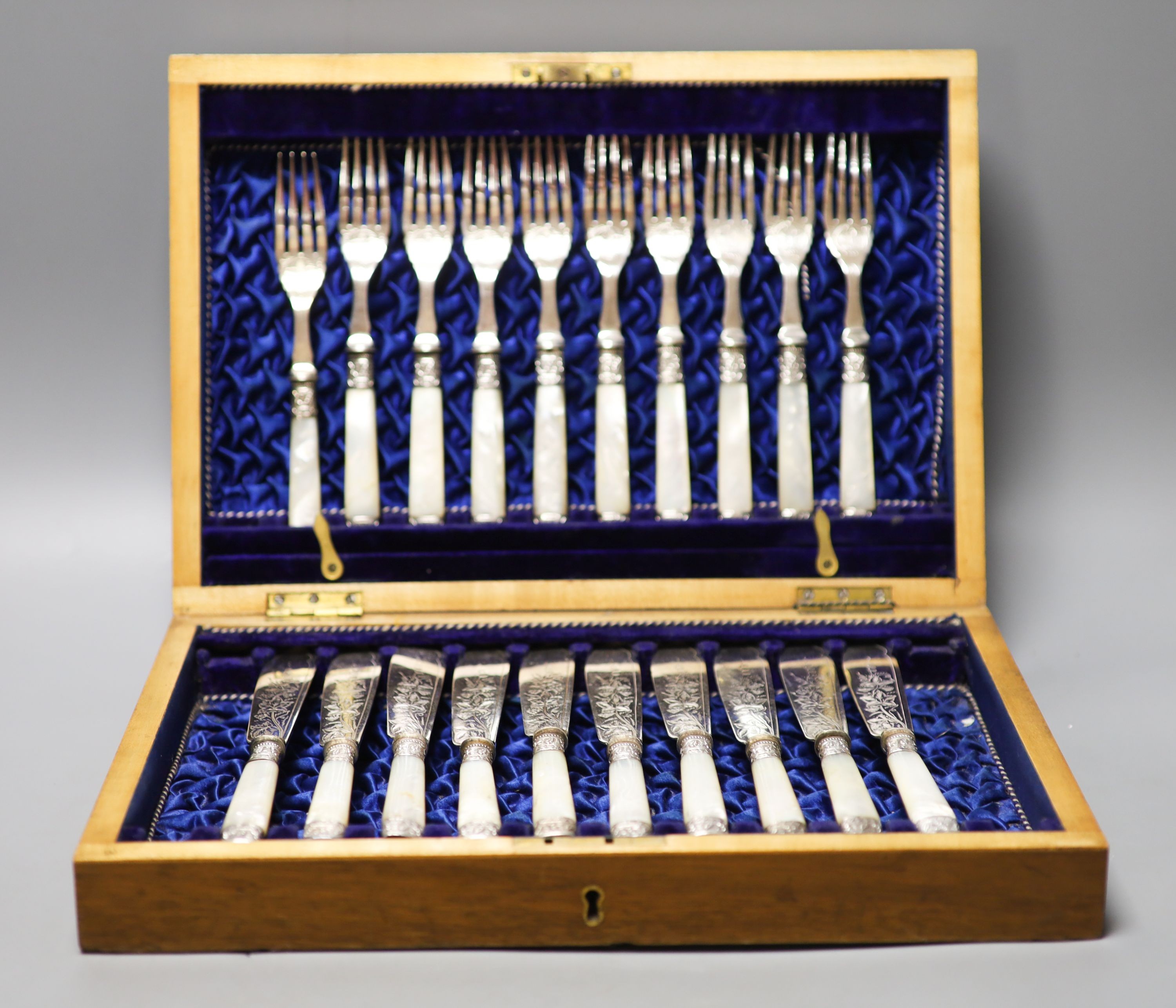 A George V cased set of six pairs of mother of pearl handled silver dessert eaters, Sheffield, 1912 and a plated part set.